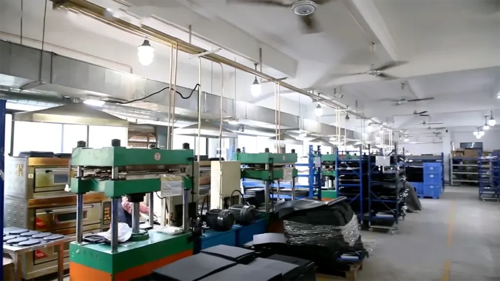 Inside view of EVA CustomPro manufacturing facility featuring automated heat pressing machines and organized production workshop.