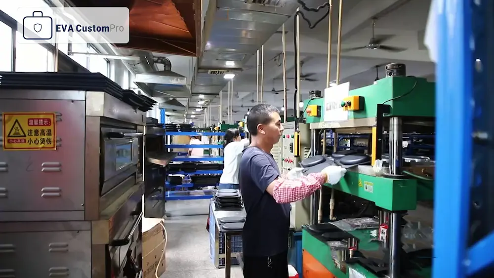 Custom EVA case manufacturing workshop showing workers operating hydraulic thermoforming heat press machines.