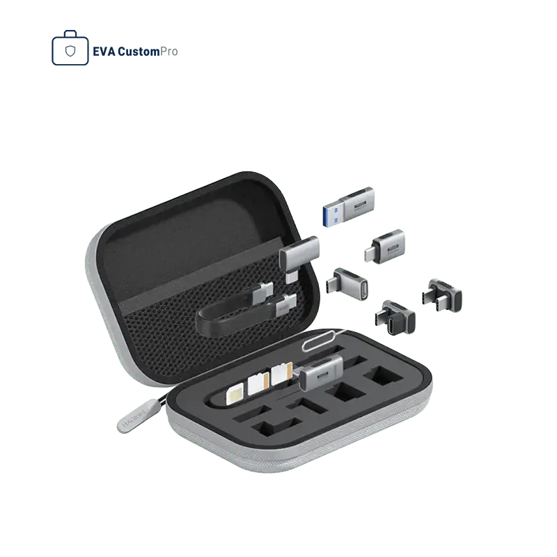 Compact grey EVA storage case open with precision die-cut foam insert for USB adapters, SD cards, SIM ejector tool, and upper mesh pocket.